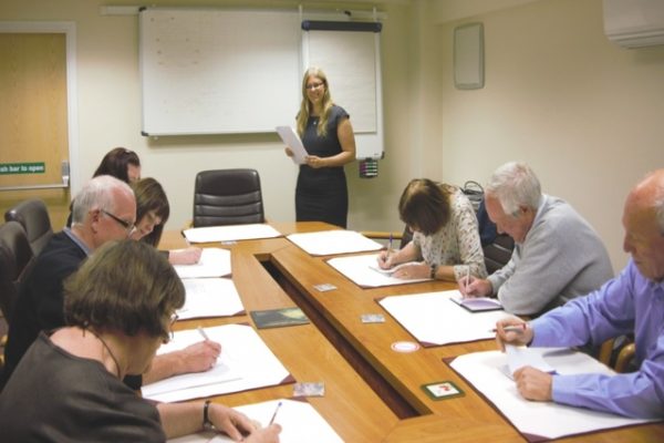 Image showing managing director training a group of adults in a boardroom