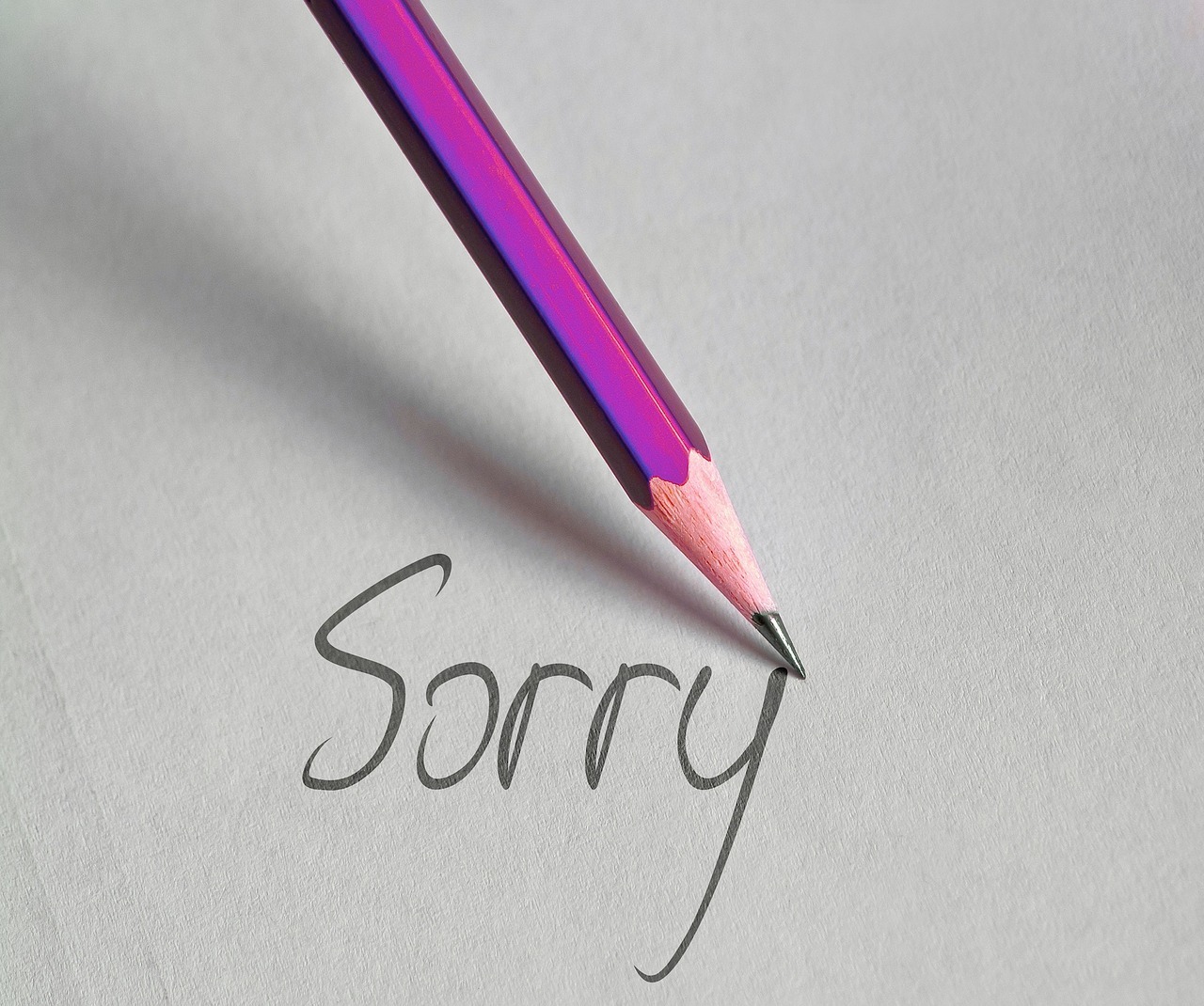 Pen writing sorry